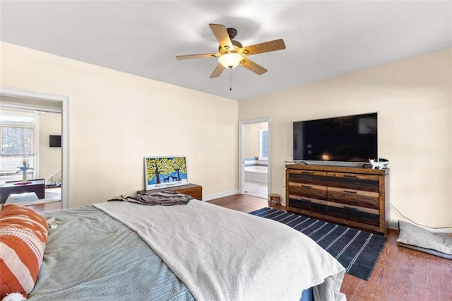 bedroom featuring dark wood-type flooring, ceiling fan, and ensuite bath