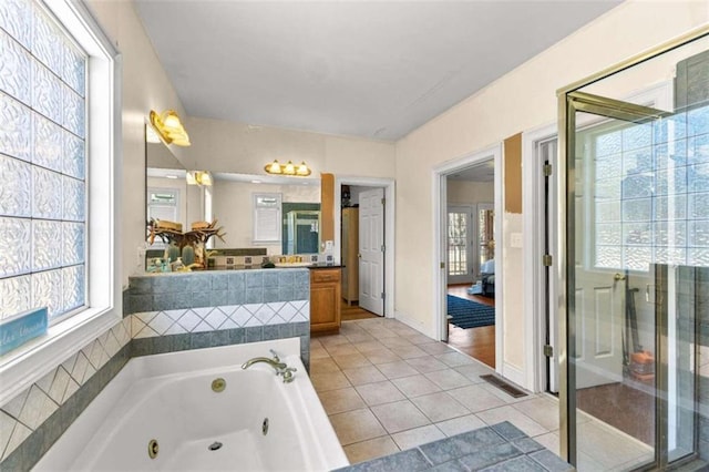 bathroom with independent shower and bath, tile patterned flooring, and vanity