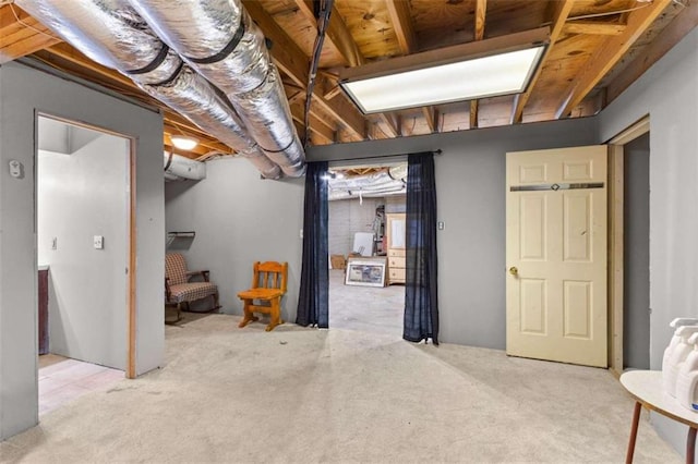 basement featuring light carpet