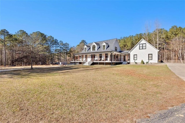 new england style home featuring a front yard and covered porch