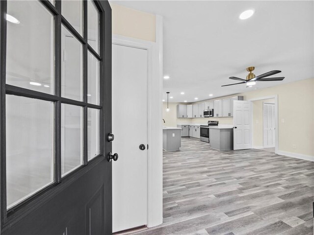 239 Brown Dr, Clermont, GA 30527 - kitchen with light wood-type flooring, a ceiling fan, recessed lighting, stainless steel appliances, and light countertops
