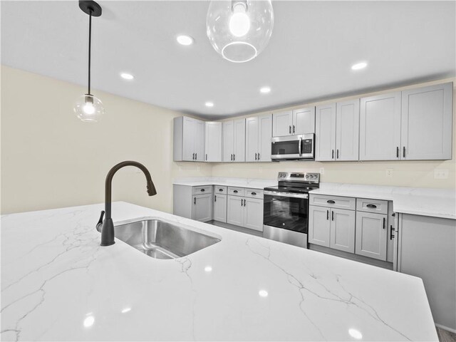 239 Brown Dr, Clermont, GA 30527 - kitchen featuring gray cabinets, a sink, light stone counters, recessed lighting, and appliances with stainless steel finishes
