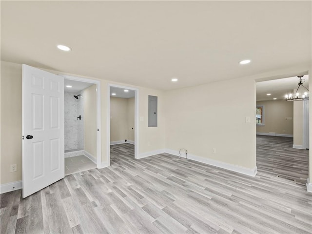 239 Brown Dr, Clermont, GA 30527 - unfurnished room featuring baseboards, electric panel, recessed lighting, light wood-type flooring, and a chandelier