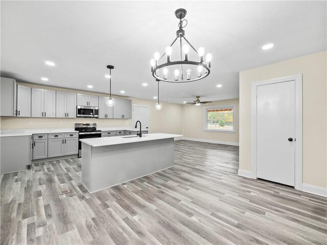 239 Brown Dr, Clermont, GA 30527 - kitchen featuring light wood finished floors, a sink, gray cabinetry, light countertops, and appliances with stainless steel finishes