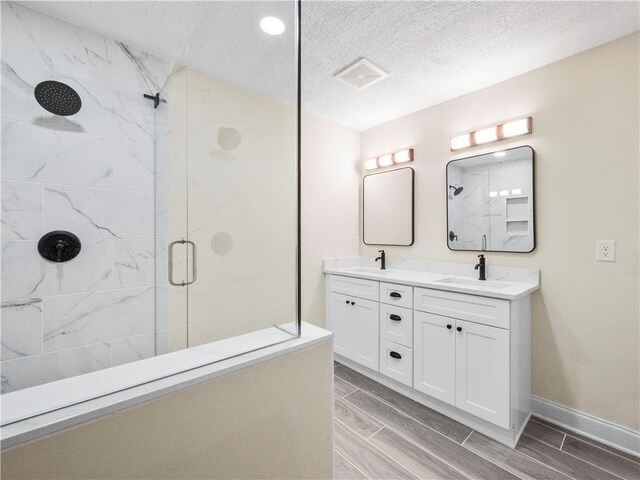 239 Brown Dr, Clermont, GA 30527 - full bath featuring a sink, wood finish floors, double vanity, and a shower stall