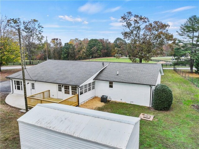 239 Brown Dr, Clermont, GA 30527 - back of house featuring central AC unit, fence, roof with shingles, a deck, and a lawn