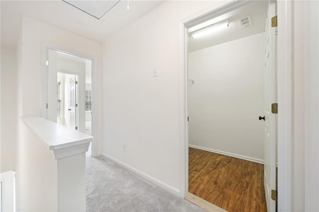 hallway featuring light colored carpet