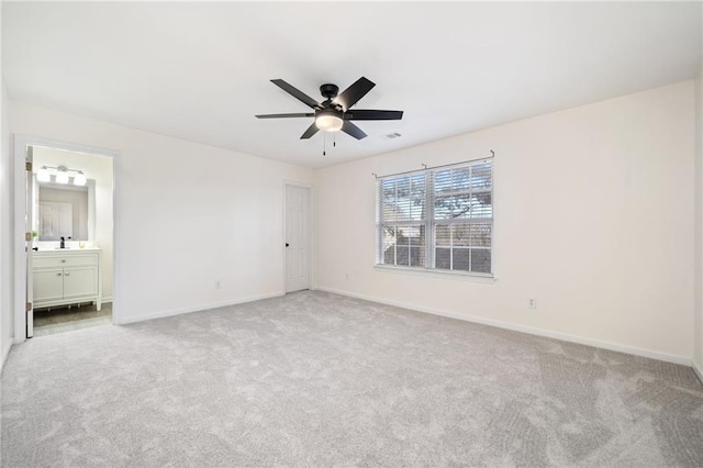 carpeted empty room featuring sink and ceiling fan