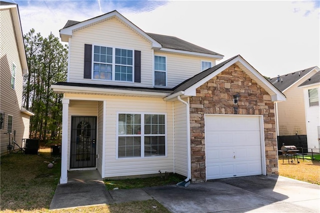 view of front of home with a garage and central AC