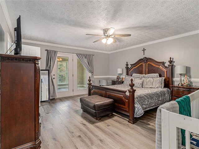 bedroom with ornamental molding, wood finished floors, and access to exterior