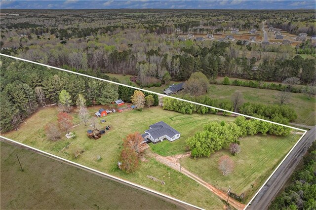 bird's eye view featuring a forest view and a rural view