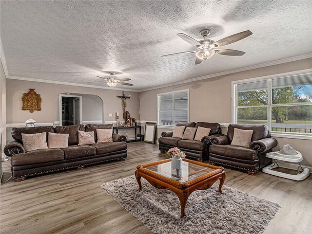 living area featuring a textured ceiling, a ceiling fan, and wood finished floors
