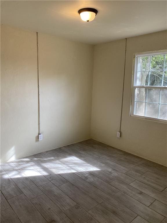 spare room featuring wood finished floors