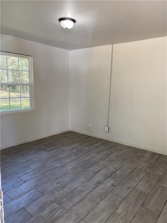 spare room featuring wood finished floors