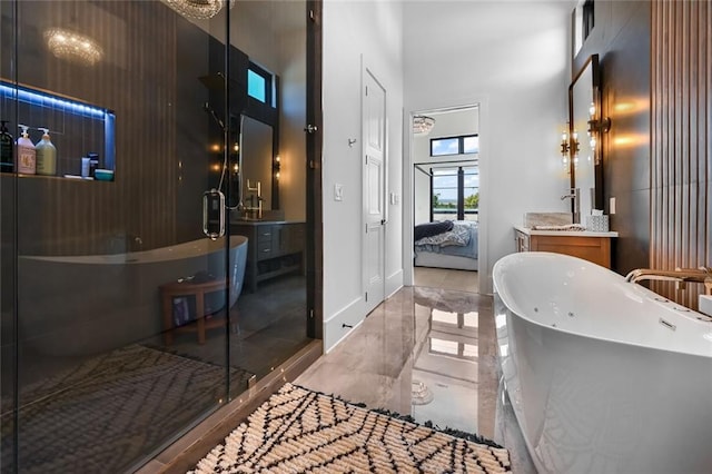 8200 Main St S Unit 1306, Woodstock, GA 30188 - bathroom featuring marble tiled flooring, ensuite bath, a high ceiling, vanity, and a freestanding tub