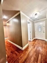 foyer entrance featuring hardwood / wood-style flooring and crown molding