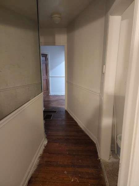 corridor with dark hardwood / wood-style floors