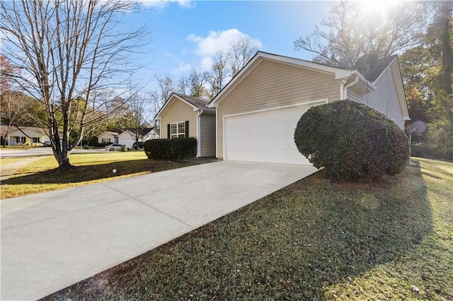 view of home's exterior with a yard and a garage