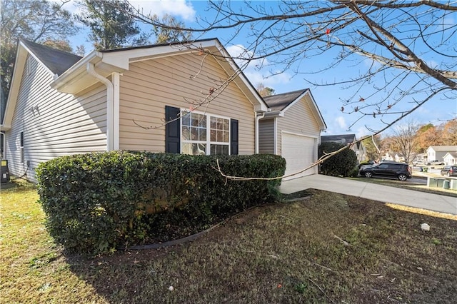 view of side of home with a yard and a garage