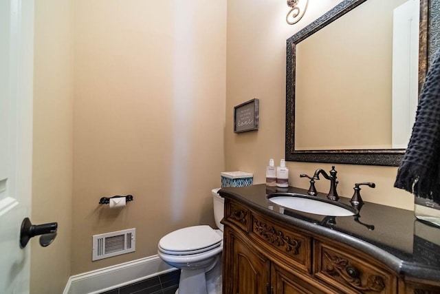 bathroom featuring toilet, tile flooring, and large vanity