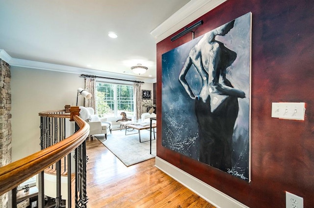 hall featuring light hardwood / wood-style floors and ornamental molding