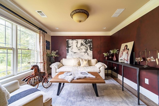 living area with crown molding and light wood-type flooring