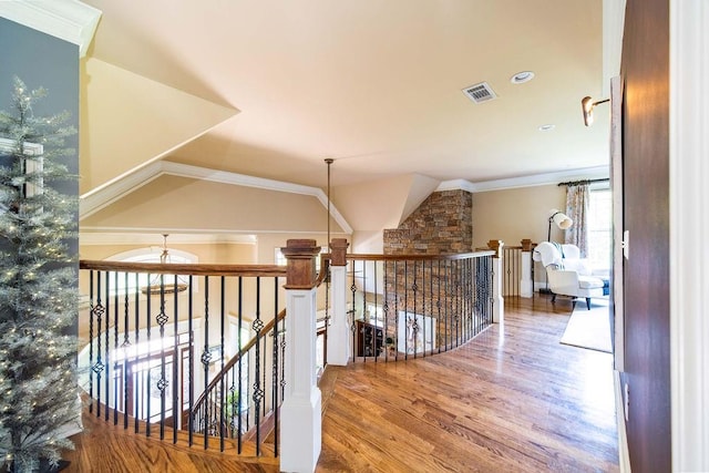 hallway with light hardwood / wood-style floors and ornamental molding