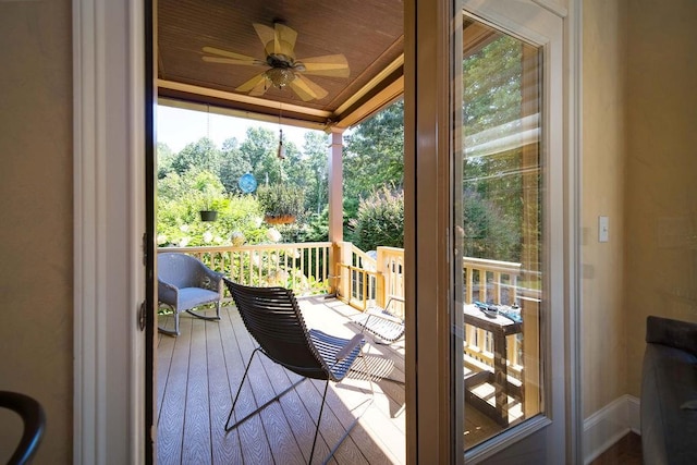 wooden deck featuring ceiling fan