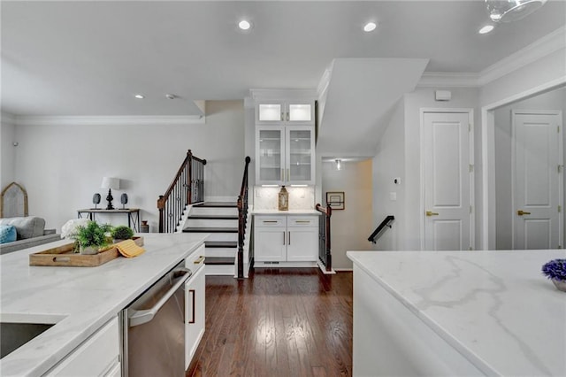 kitchen featuring dishwasher, light stone counters, white cabinetry, and crown molding