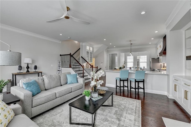 living room featuring stairway, ornamental molding, dark wood-type flooring, and recessed lighting