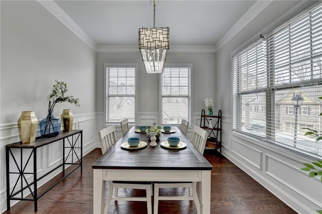 dining area featuring a notable chandelier, dark wood-type flooring, and crown molding