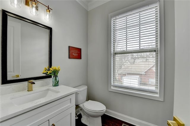 bathroom featuring baseboards, vanity, and toilet