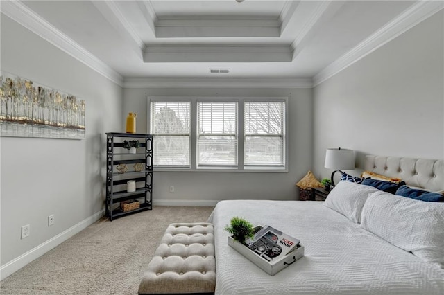 carpeted bedroom featuring baseboards, ornamental molding, and a raised ceiling