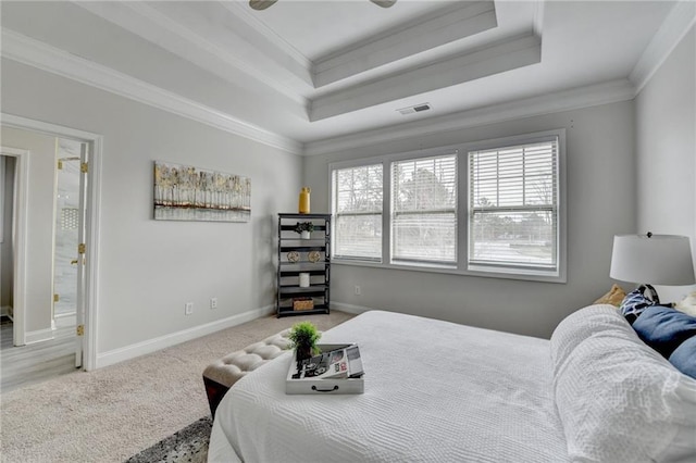 bedroom with baseboards, carpet, a tray ceiling, and crown molding