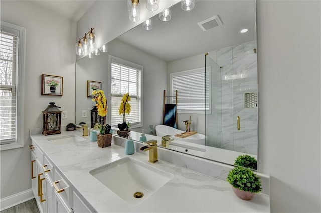 full bath featuring a freestanding tub, a sink, visible vents, double vanity, and a stall shower