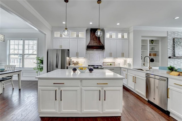 kitchen featuring stainless steel appliances, premium range hood, a sink, light countertops, and ornamental molding