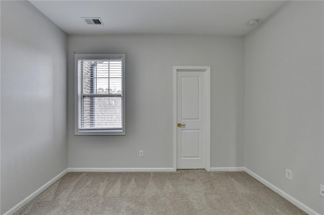 carpeted spare room with baseboards and visible vents