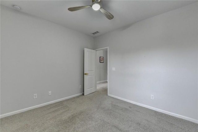 spare room featuring a ceiling fan, carpet, visible vents, and baseboards