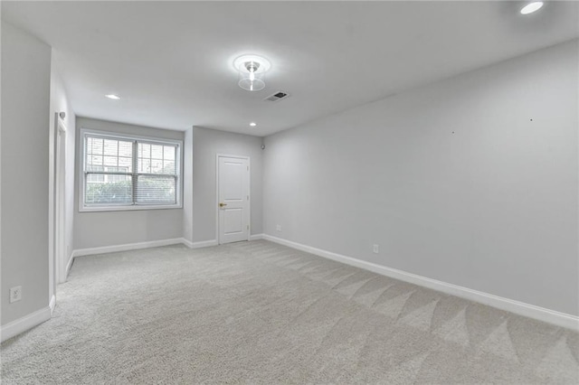 carpeted empty room with recessed lighting, visible vents, and baseboards