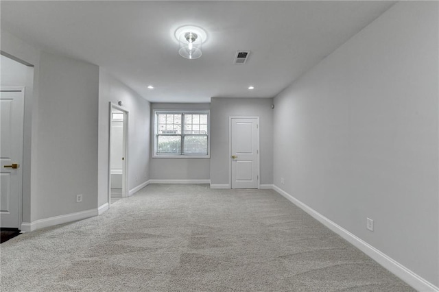 carpeted empty room with recessed lighting, visible vents, and baseboards