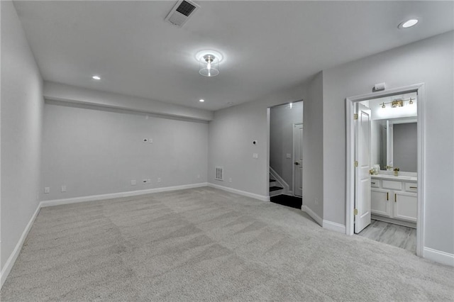 unfurnished bedroom featuring recessed lighting, visible vents, light carpet, and baseboards