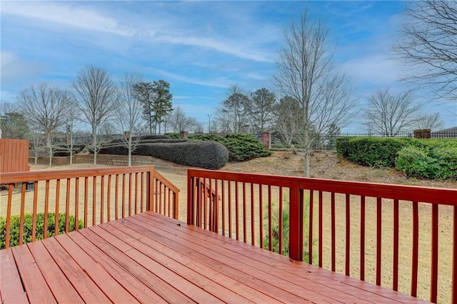 deck with a yard and fence