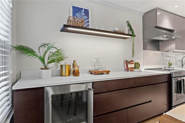 bar with wine cooler, dark brown cabinetry, and stainless steel electric range