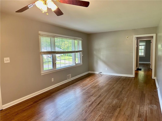 1468 Spruce Dr SE, Smyrna, GA 30080 - spare room with dark wood-style floors, baseboards, and ceiling fan