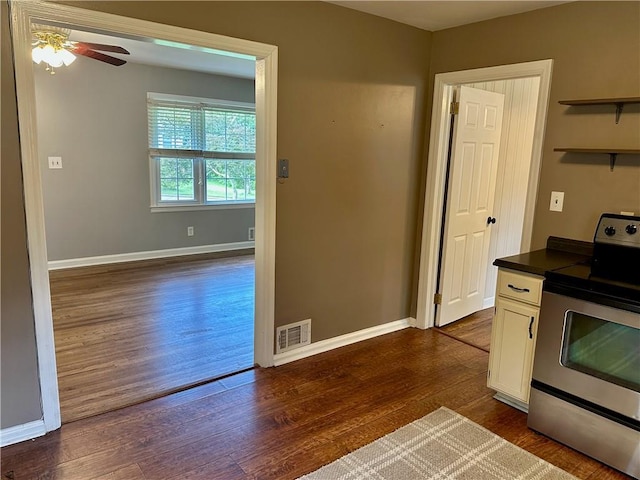 1468 Spruce Dr SE, Smyrna, GA 30080 - kitchen featuring stainless steel range with electric cooktop, dark wood-type flooring, a ceiling fan, white cabinetry, and dark countertops