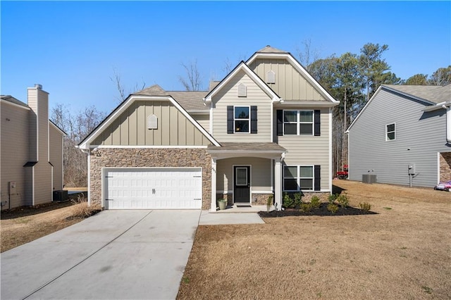 craftsman house with driveway, central AC, stone siding, a garage, and board and batten siding