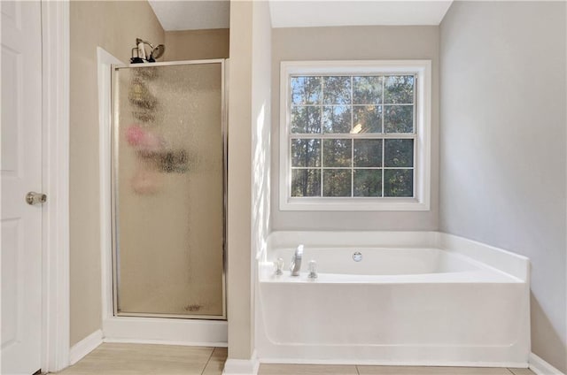 bathroom featuring separate shower and tub