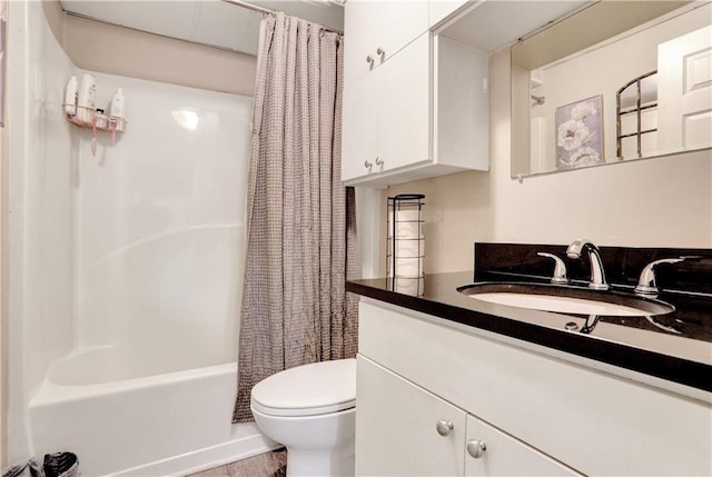 full bathroom with shower / tub combo, vanity, and toilet