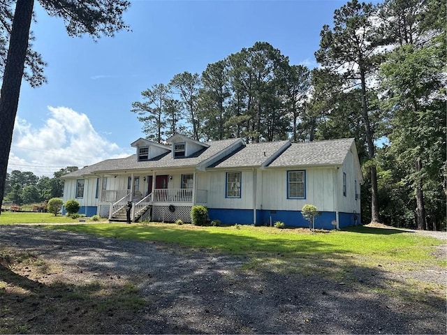 1833 Stephenson Rd, Lithonia, GA 30058 - view of front of house featuring covered porch, a front lawn, roof with shingles, and board and batten siding
