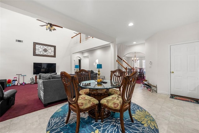 dining room with ceiling fan with notable chandelier